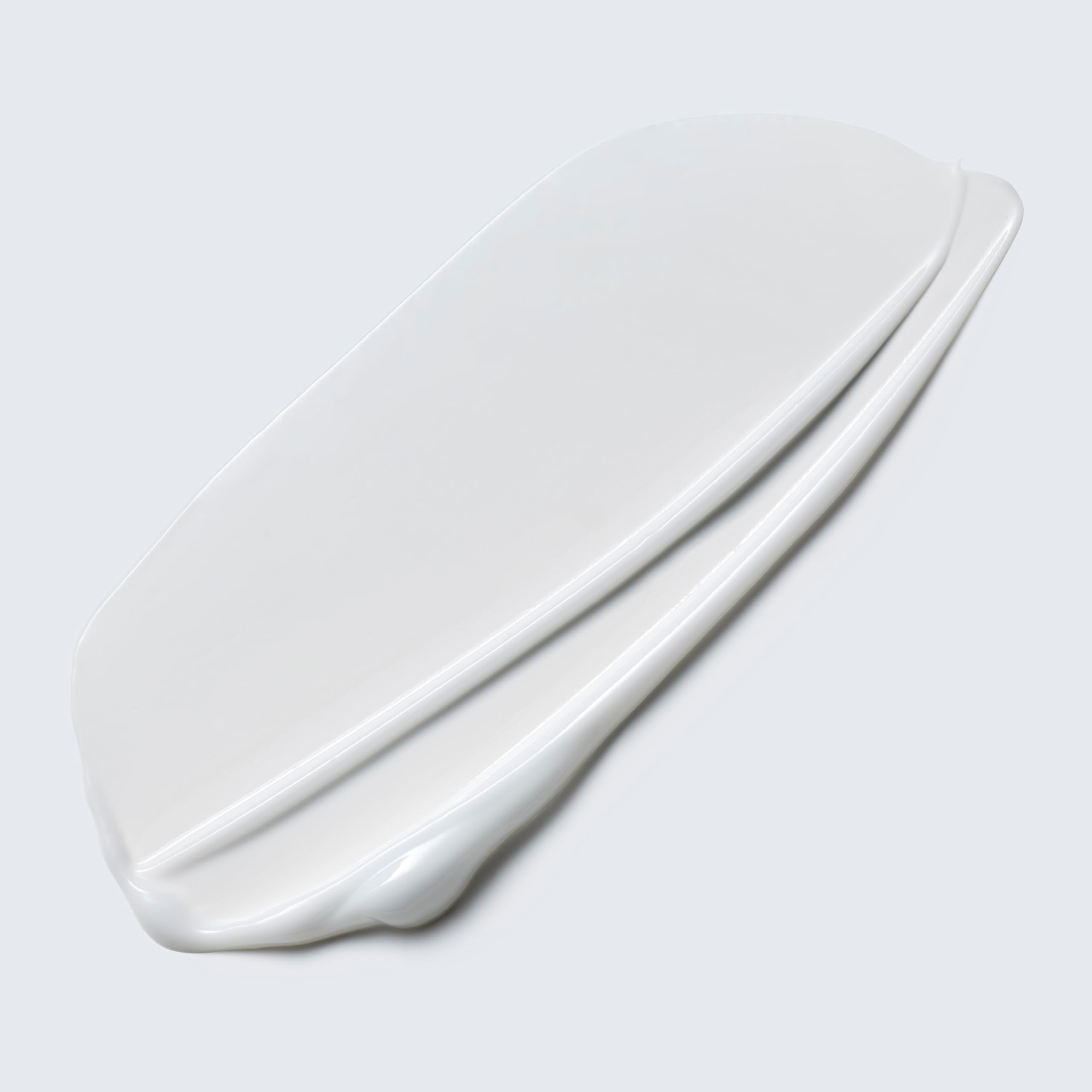Estée Lauder Take It Away lotion texture close-up highlights smooth cleansing.