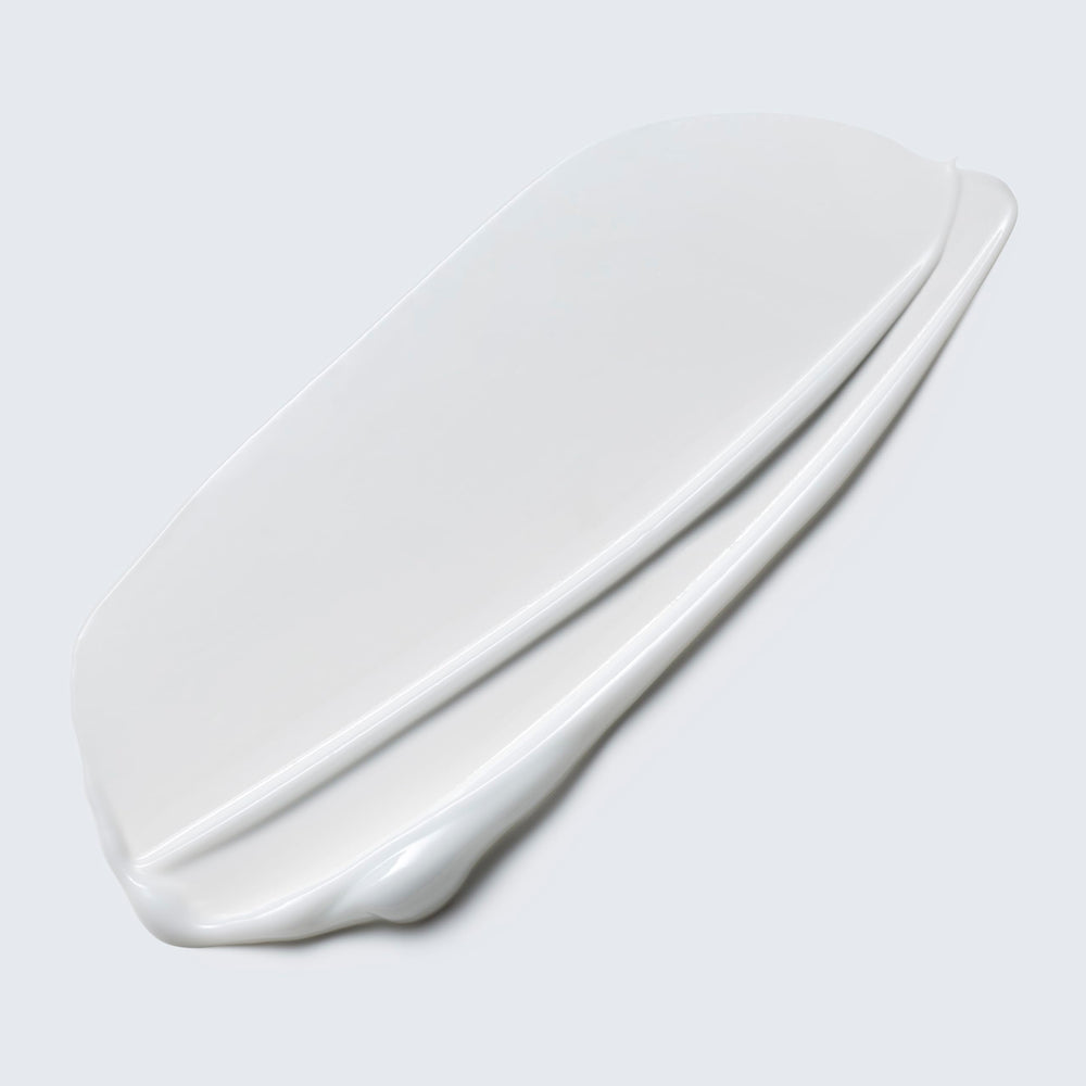 Estée Lauder Take It Away lotion texture close-up highlights smooth cleansing.