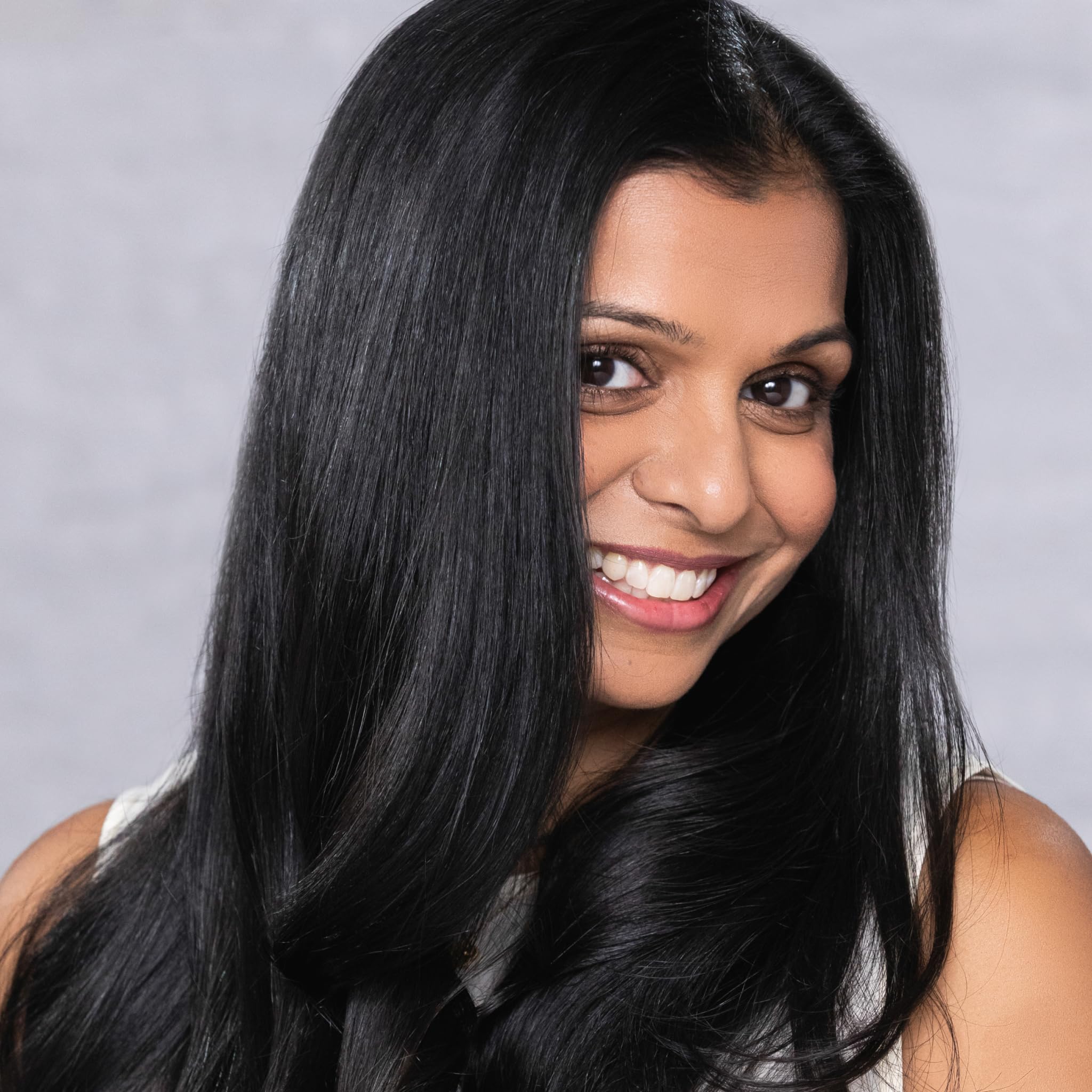 EVOLVh UltraShine on curly hair offering softness and manageability