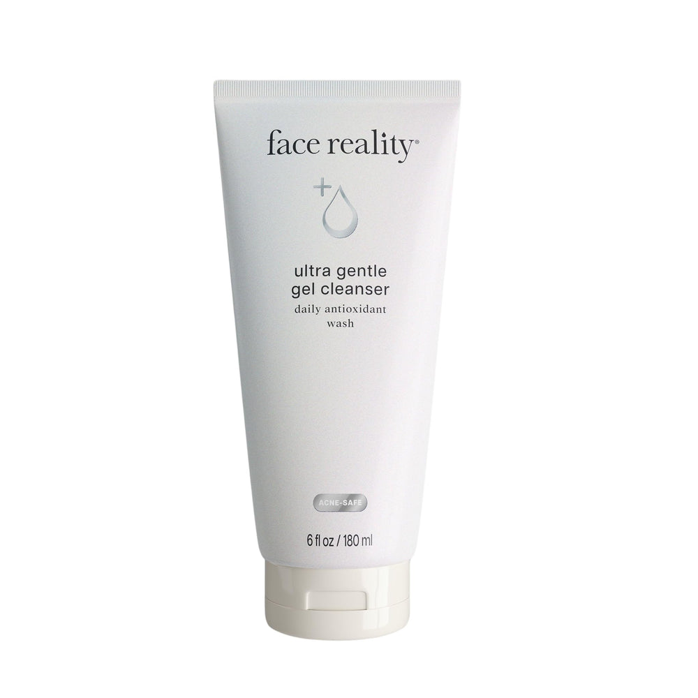 Face Reality Ultra Gentle Cleanser bottle on bathroom shelf for daily makeup removal.