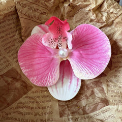 Faucye butterfly orchid clip enhances wedding or celebration looks.