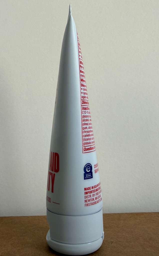 First Aid Beauty Ultra Repair Cream applied to skin for versatile head-to-toe moisture.