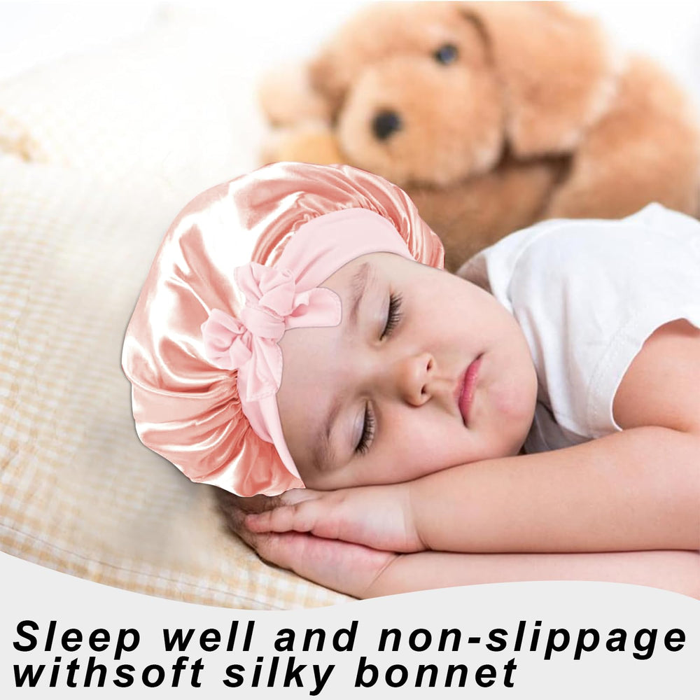 FIRSTPELLA satin bonnet with bow keeps hair tidy.
