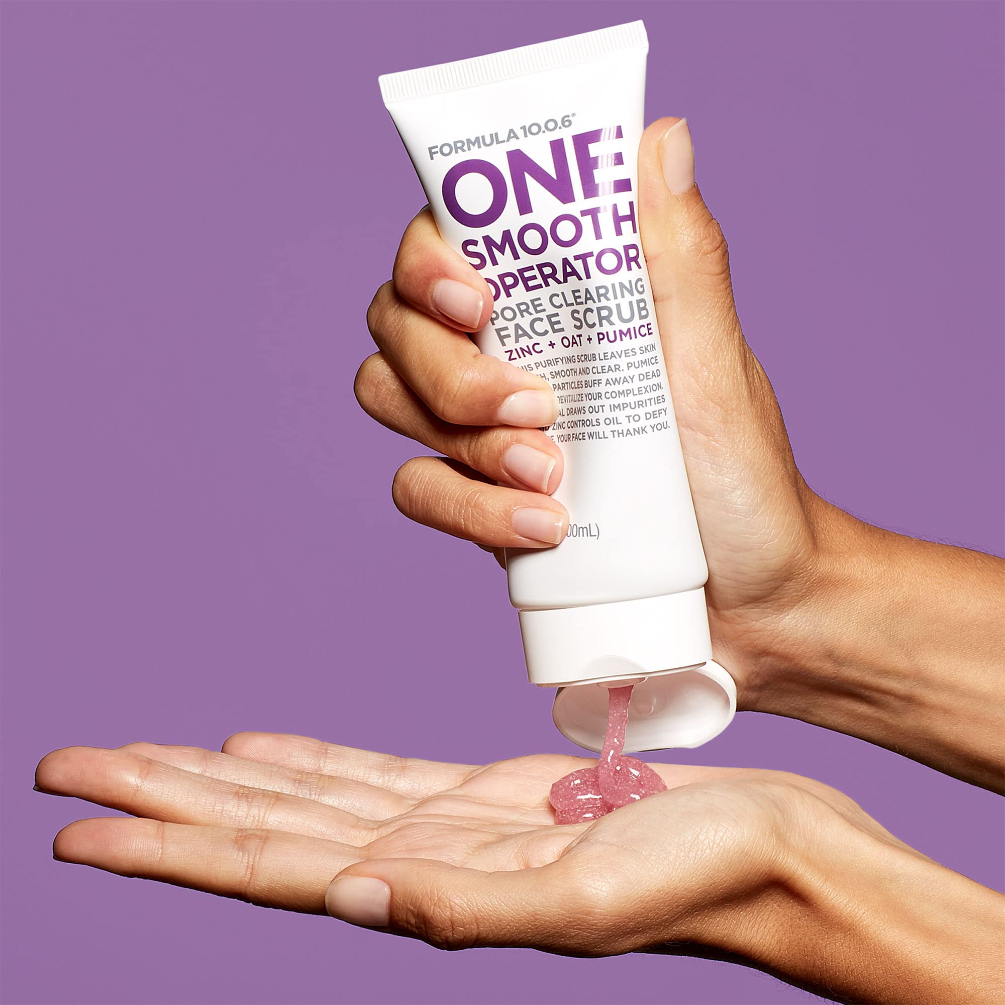 Applying Formula 10.0.6 face scrub to the face for even coverage.