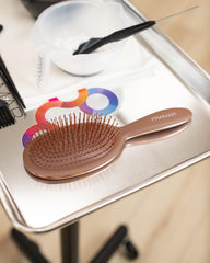 FRAMAR chocolate brush closeup shows flexible bristles for painless detangling