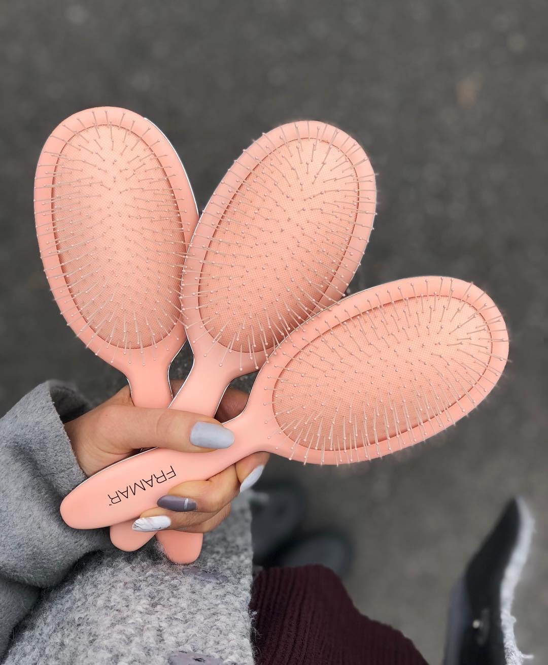 Framar Detangling Brush with ergonomic handle for secure grip.
