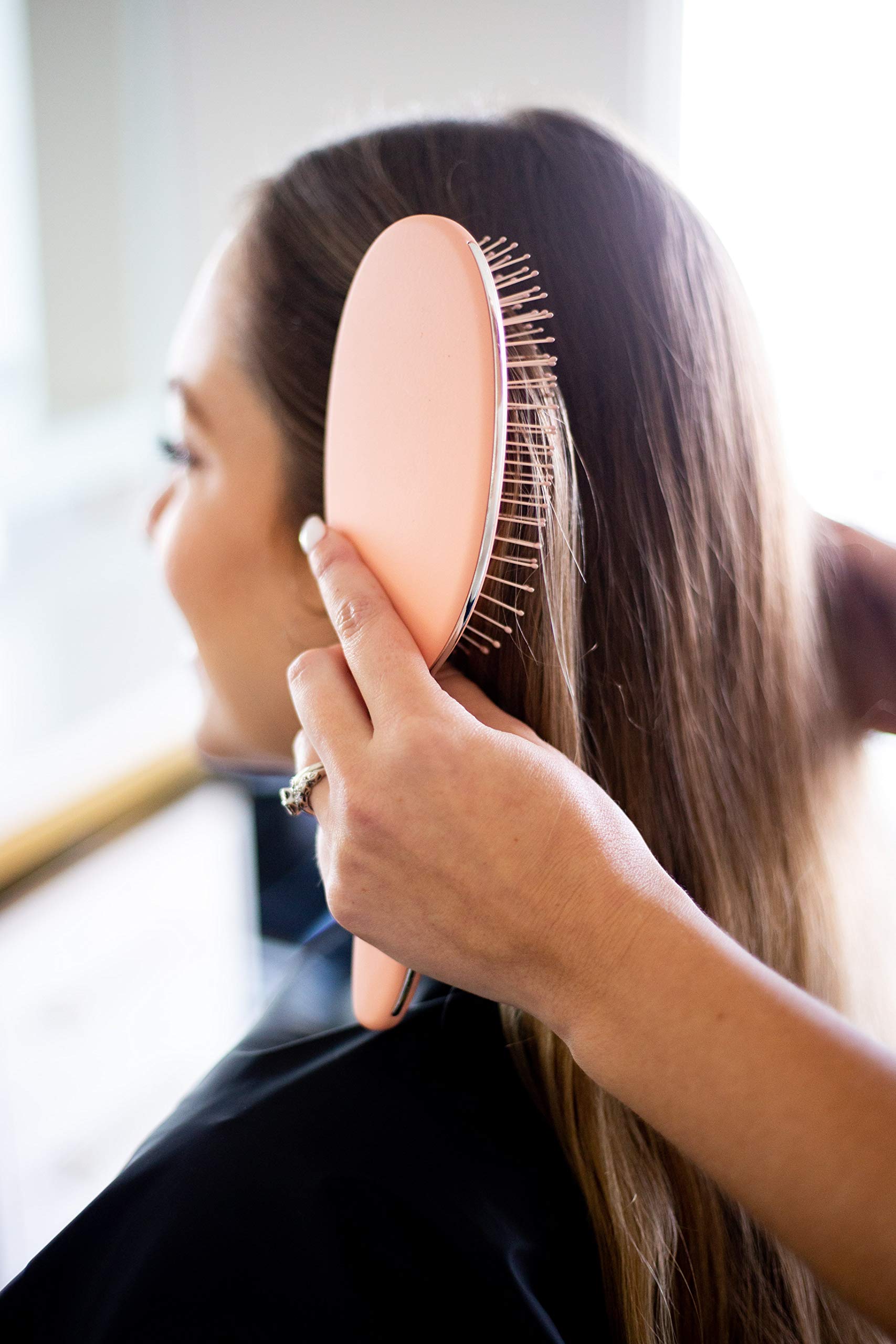 Framar brush close-up showing soft bristles for gentle detangling.