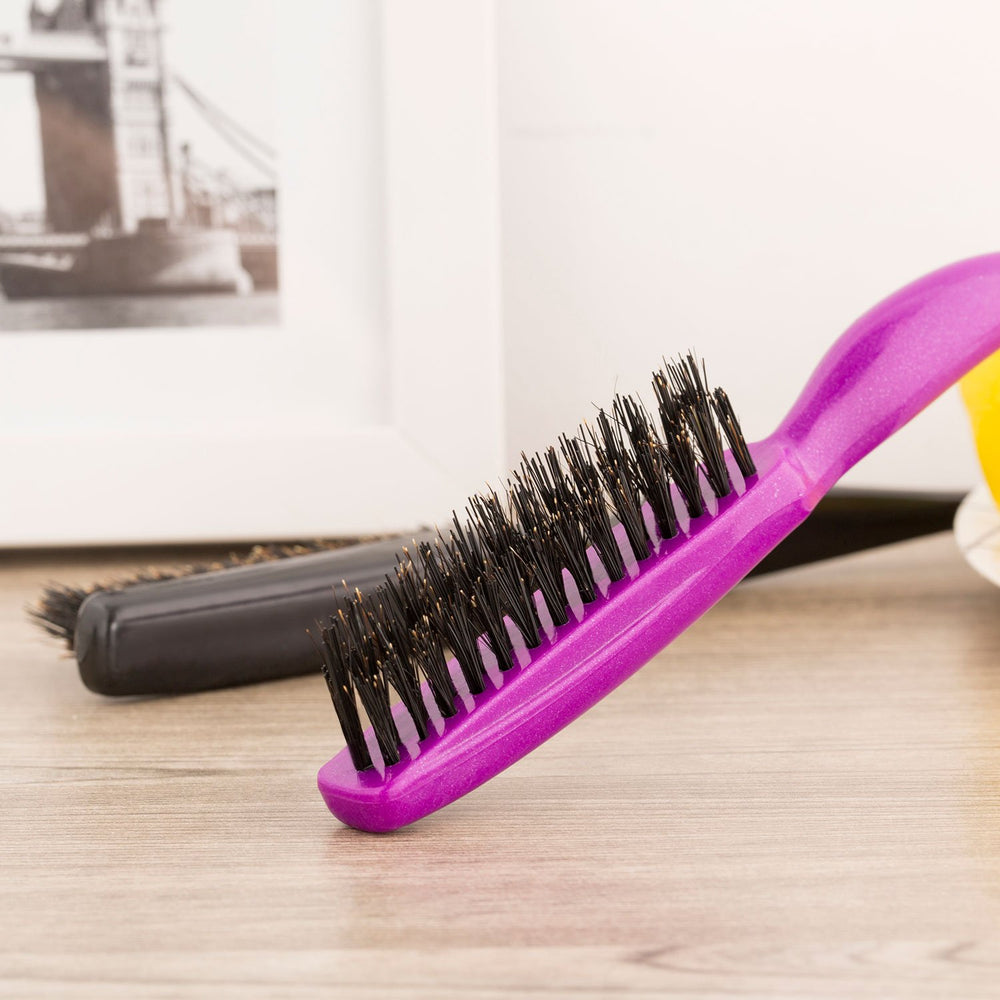 Frienda boar bristle brush close-up in fuchsia showing even oil distribution.