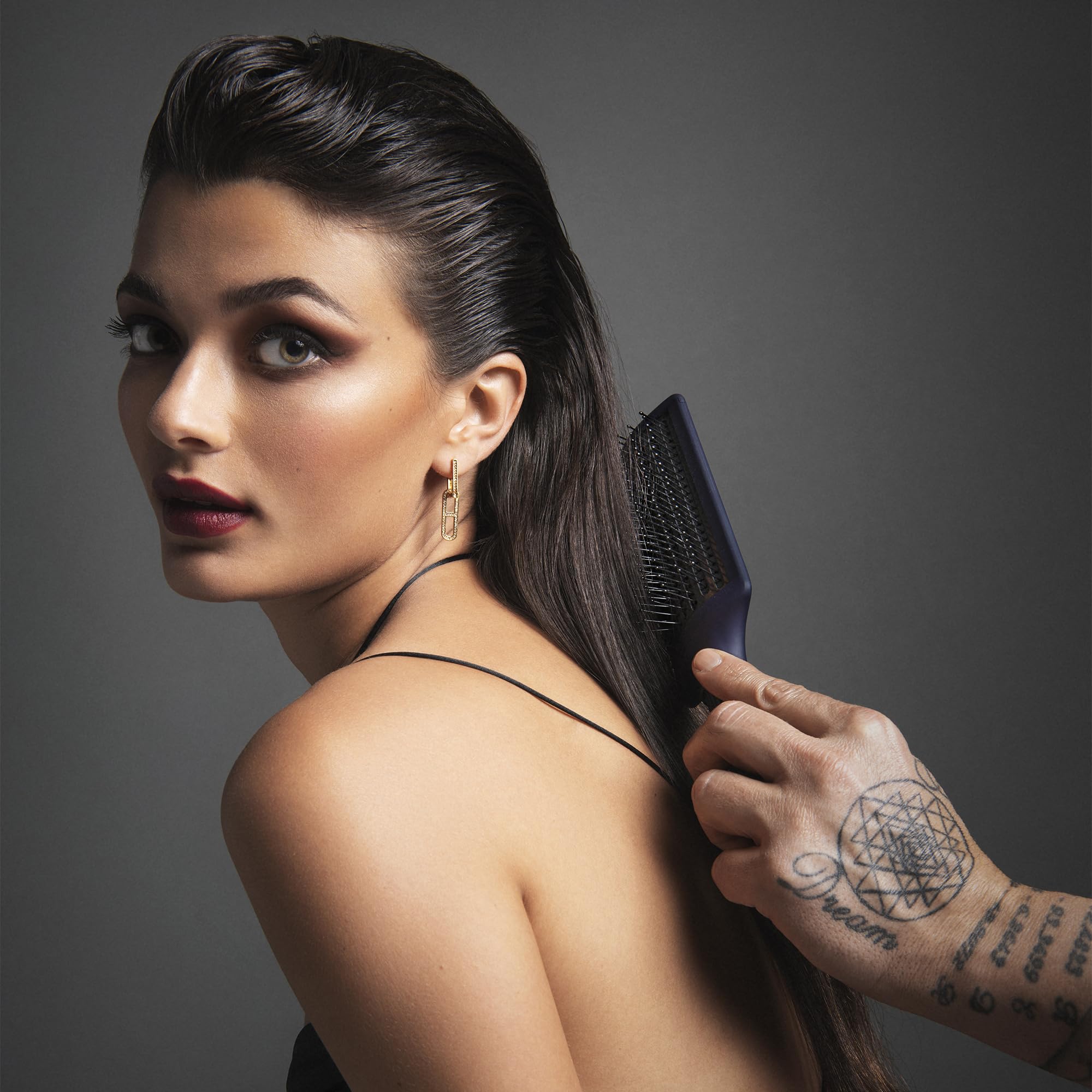 Fromm Intuition anti-static paddle brush reducing frizz and flyaways for a sleek look.