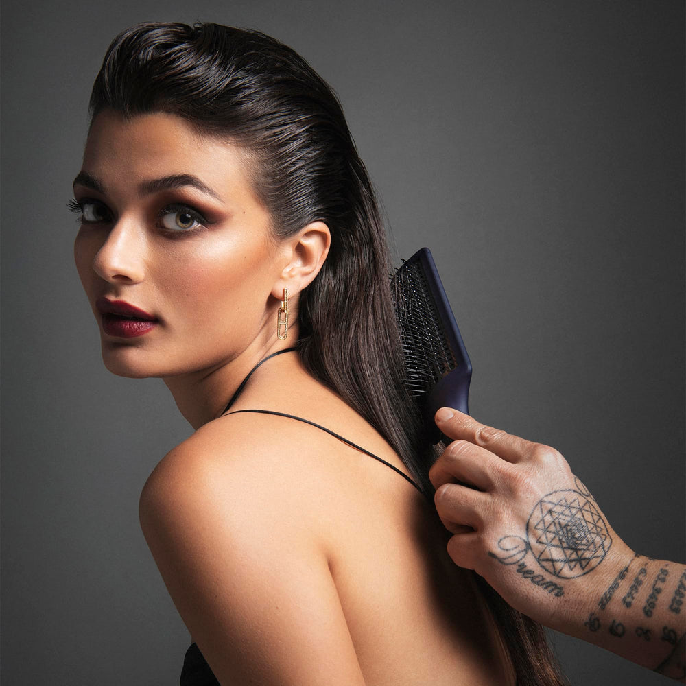Fromm Intuition anti-static paddle brush reducing frizz and flyaways for a sleek look.