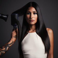 Fromm Intuition curved-base paddle brush lifting roots for added volume during styling.
