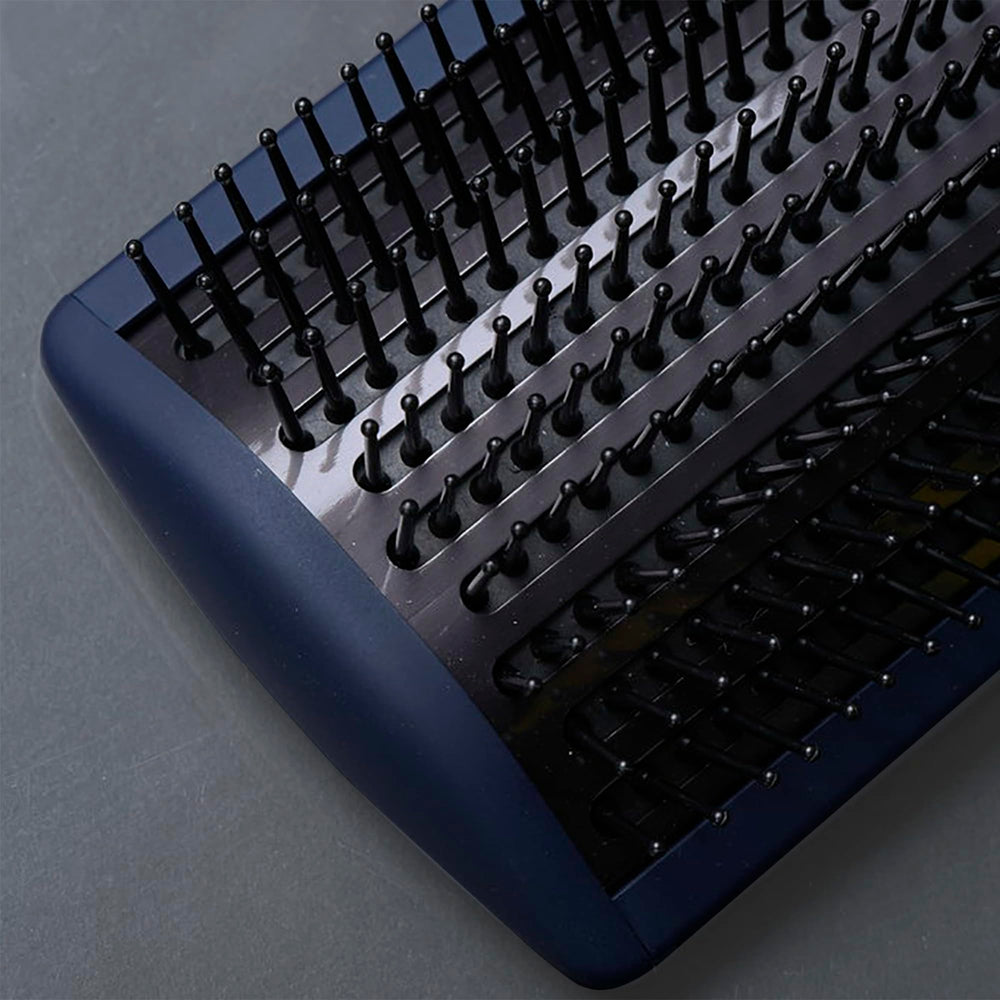 Fromm Intuition paddle brush demonstrating full-size coverage for larger hair sections.