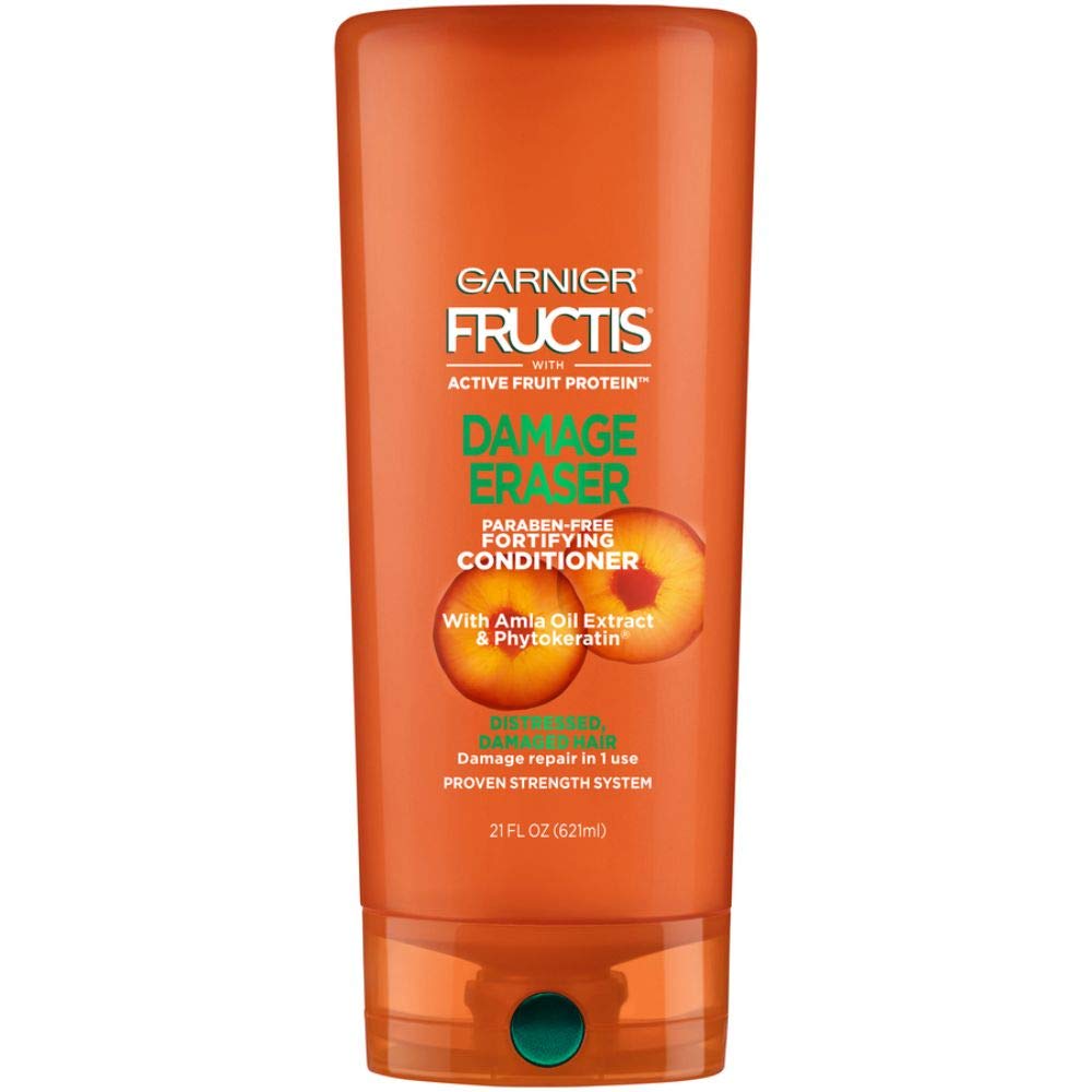 Garnier Fructis Damage Eraser conditioner bottle being poured for stronger hair