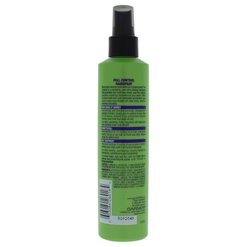 Garnier Fructis Full Control hairspray being applied for a touchable, frizz-free finish.