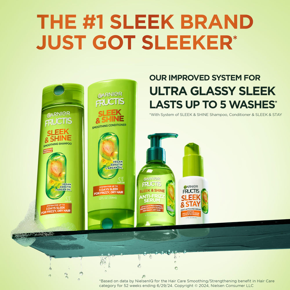Applying Garnier Sleek & Shine conditioner from roots to tips for smooth hair.