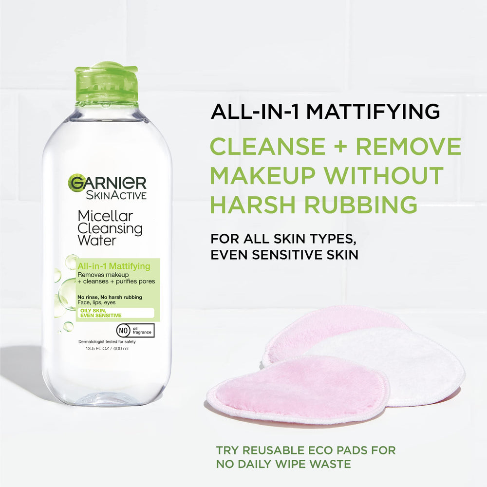 Garnier Micellar Water on a cotton pad lifting makeup with ease.