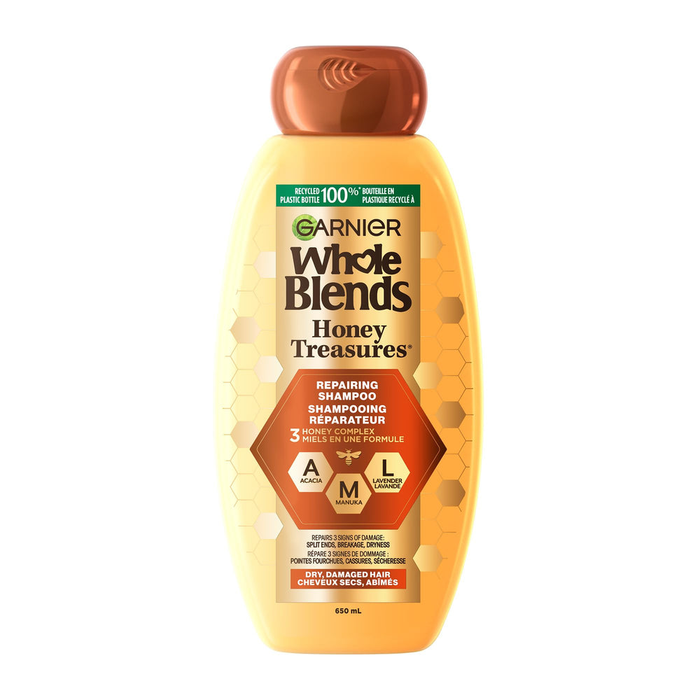 Garnier Whole Blends Reparando Miel Tesoros: botella de champú con fragancia miel que nutre y fortalece cabello dañado.