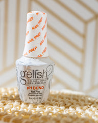 Gelish pH Bond applied to nails to balance pH and reduce oils for better adhesion.