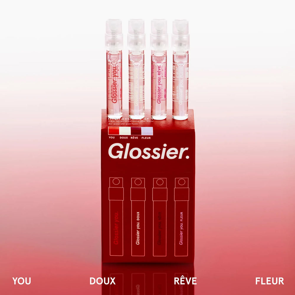 Close-up of Glossier You bottles highlighting compact travel-size packaging.