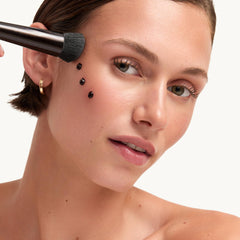 Close-up of Goop Summertone Bronzing Gel tube and creamy texture.