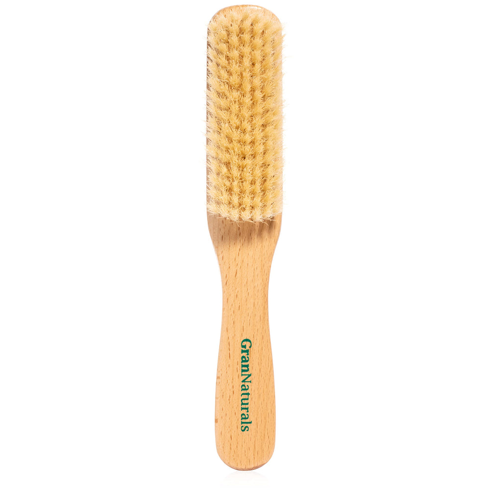 GranNaturals boar bristle brush close-up on soft white bristles for smooth styling.