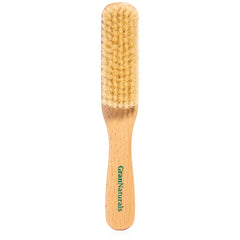 GranNaturals boar bristle brush close-up on soft white bristles for smooth styling.