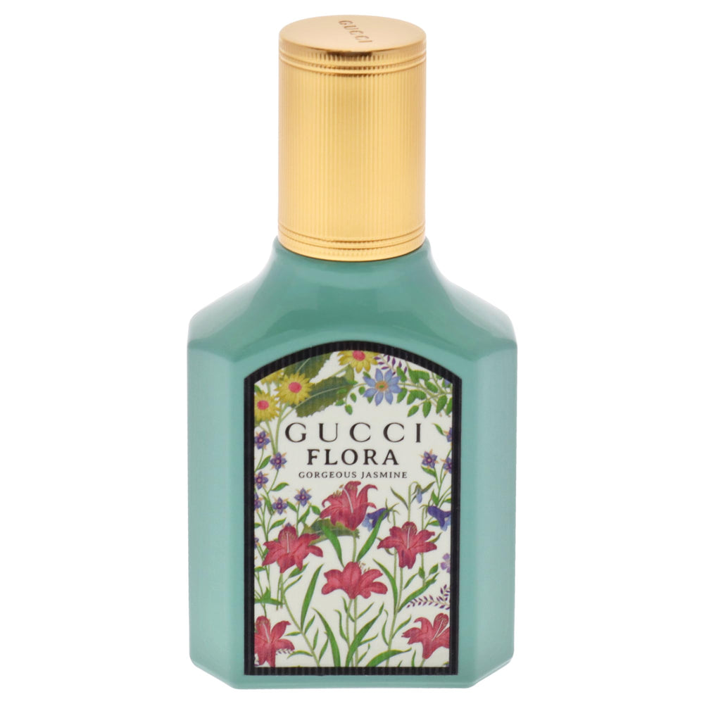 Close-up of the Gucci bottle with jasmine petals highlighting floral notes.