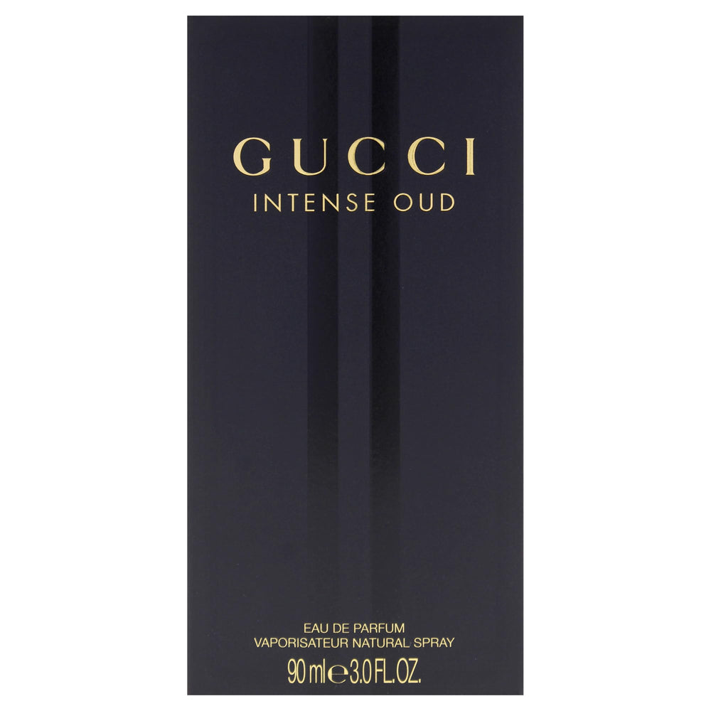 Gucci Intense Oud bottle glass facets catching light for depth.