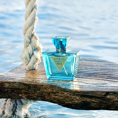 GUESS Seductive Blue lifestyle on sunlit beach, evokes seaside warmth and memories