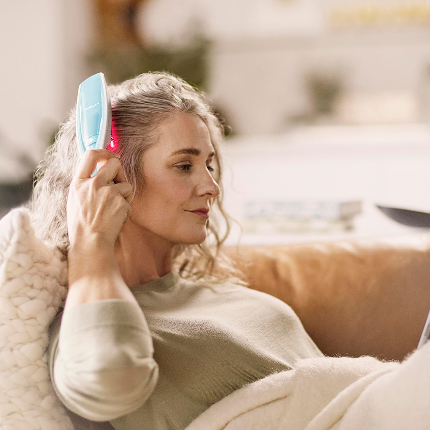 HairMax Ultima 12 Classic lasercomb in use on scalp