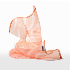 HANNI exfoliating loofah-like cloth demonstrates gentle body polish.