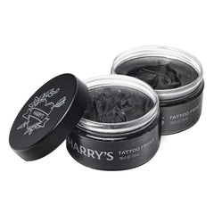 Harry’s Tattoo Frost bottle demonstrates lightweight hydration for vibrant tattoos.