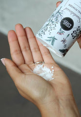 Herb & Root sandalwood dust powder jar close-up showing smooth texture for easy application.