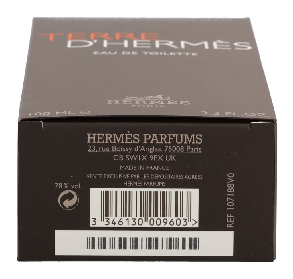 Hermès Terre d’Hermès masculine flacon on desk; evokes confident, timeless style.