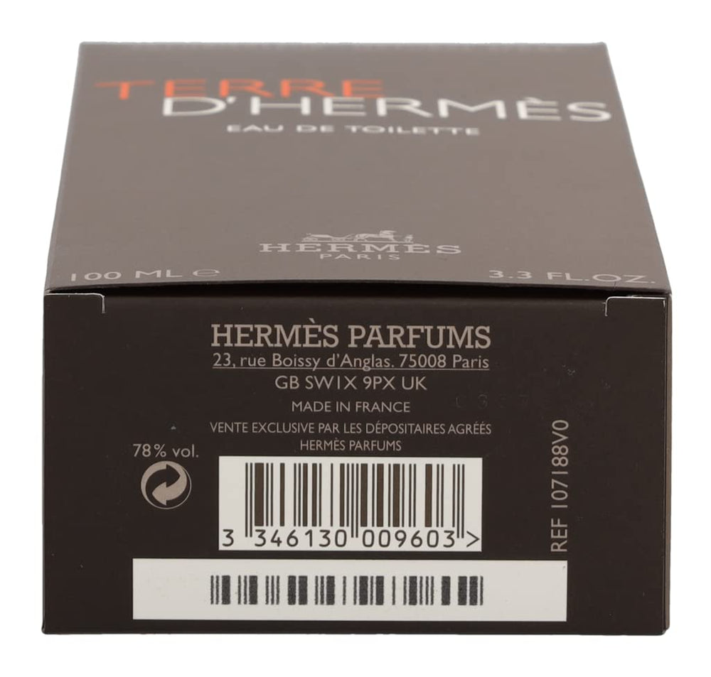 Hermès Terre d’Hermès masculine flacon on desk; evokes confident, timeless style.