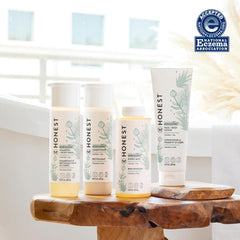 The Honest Company Hydrating Lotion applying on baby hand demonstrating gentle massage routine.