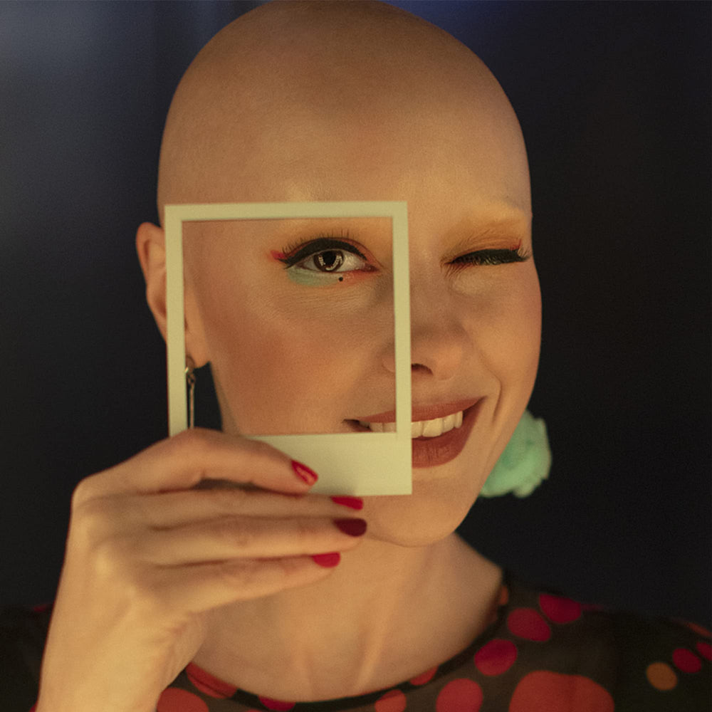 Iceyyyy bald cap being applied for seamless skin-tone blending during makeup.