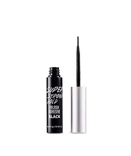 Compact i-ENVY by KISS lash glue stored in purse for quick touch-ups.