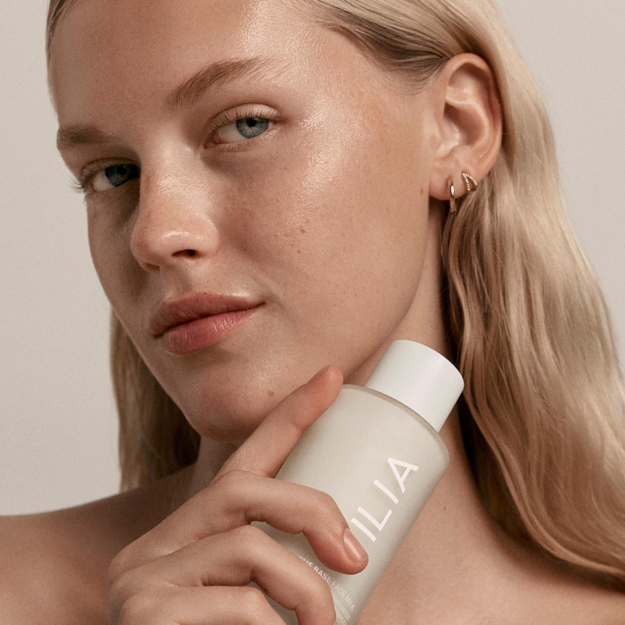 ILIA Base Face Milk texture close-up suggesting creamy, layerable moisture.