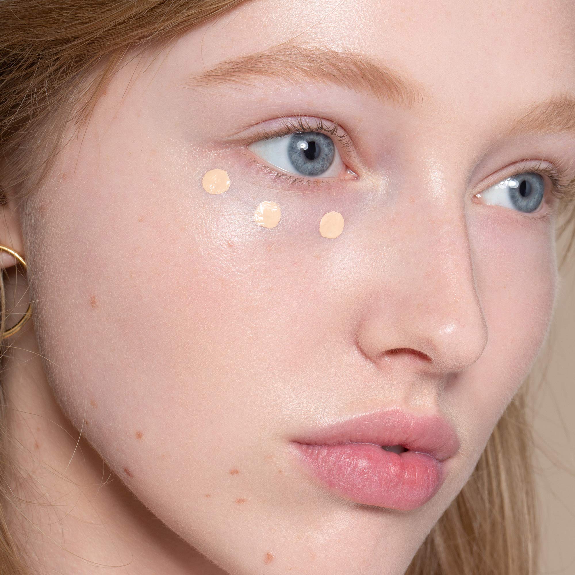 ILIA True Skin Serum Concealer cream texture glides for quick correction.
