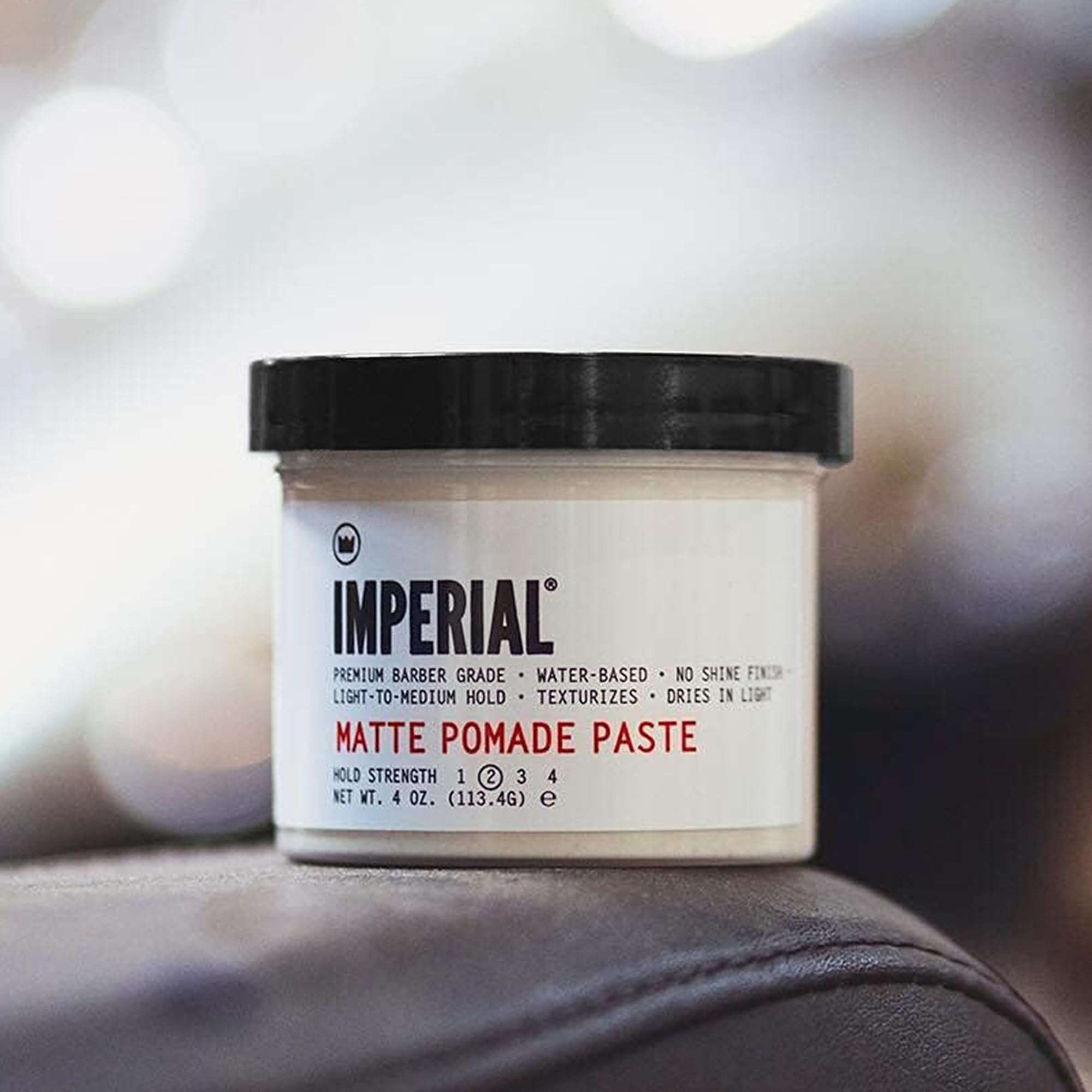 Hands applying Imperial Barber Matte Pomade Paste for smooth hold