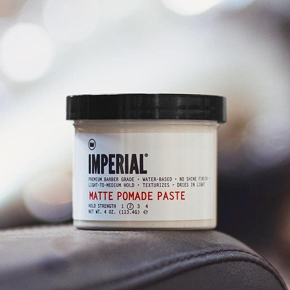 Hands applying Imperial Barber Matte Pomade Paste for smooth hold