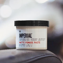 Hands applying Imperial Barber Matte Pomade Paste for smooth hold