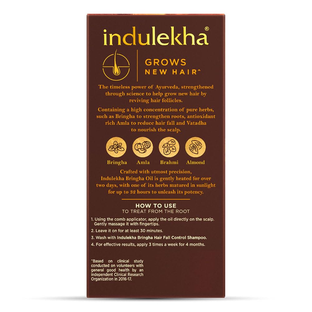 Indulekha Bringha Oil bottle closeup highlighting coconut oil base for silky hair.
