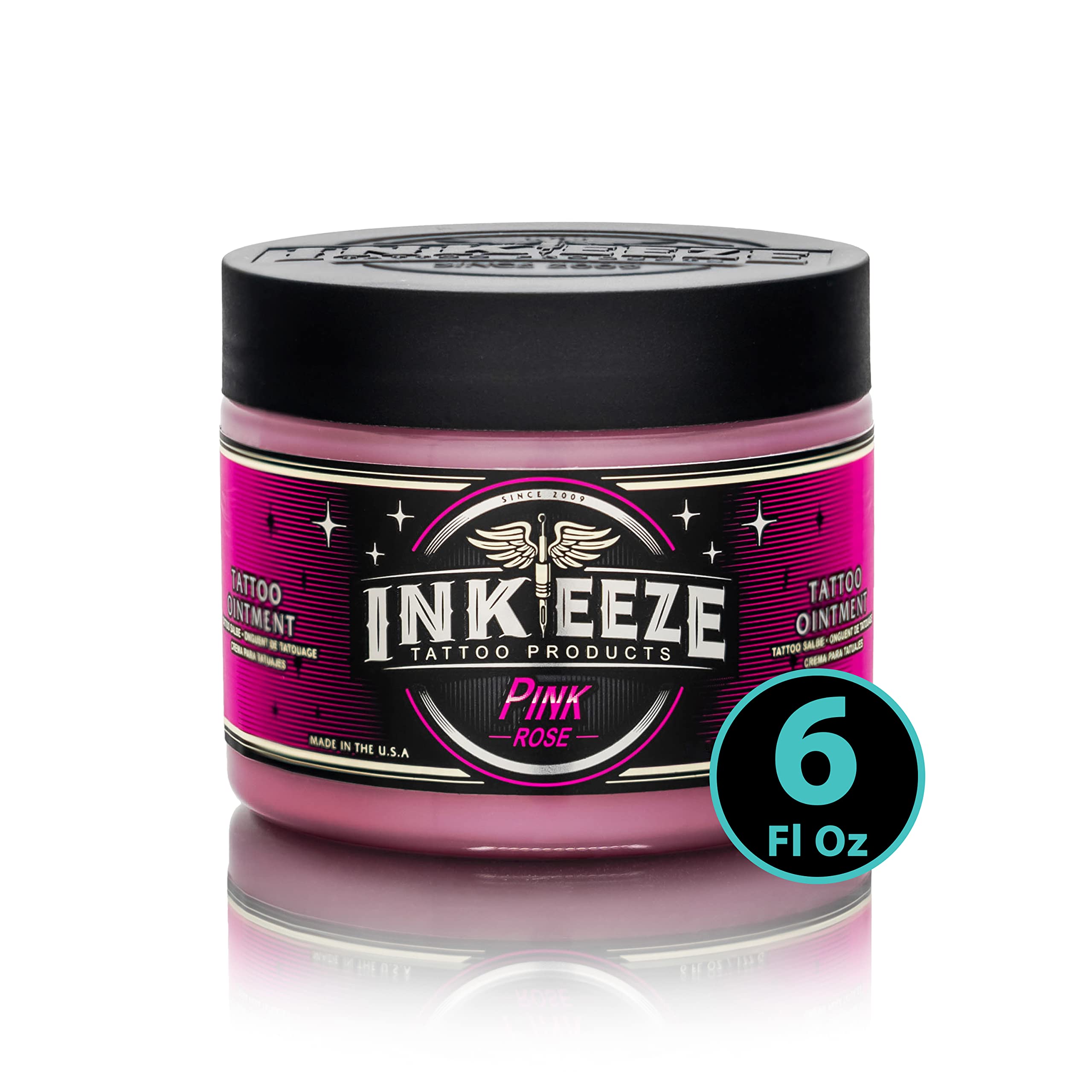 INK-EEZE Pink Tattoo Ointment bottle closeup showing vegan non-petroleum formula for smooth tattooing