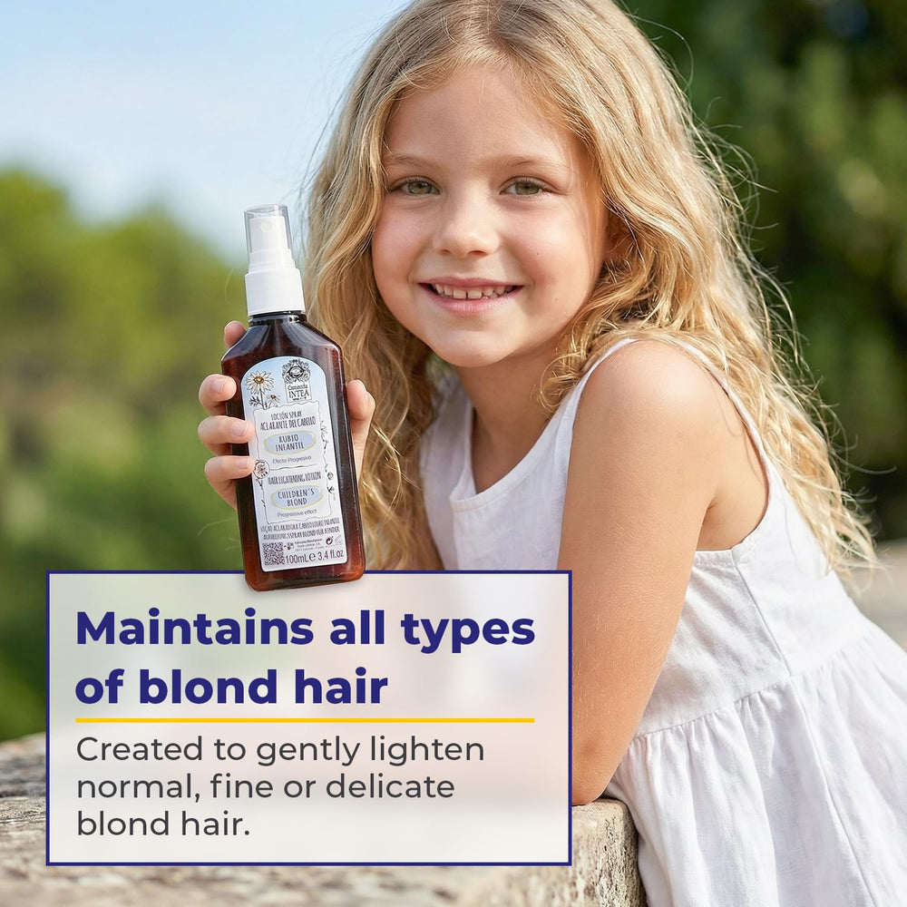 Child applying Intea Camomila lightener to targeted hair section for gradual blonding.
