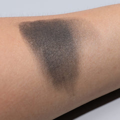 Swatch of IS'MINE black matte shadow on skin shows intense color and crease-free potential.