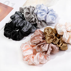 Ivyu satin scrunchies close-up shows shiny finish and smooth hair glide