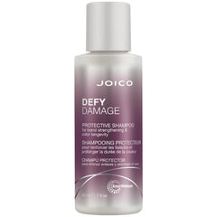 Joico Defy Damage Shampoo: botella vertiendo, limpieza suave que protege el color.