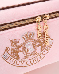 Juicy Couture pink makeup bag interior lined to protect brushes and bottles.